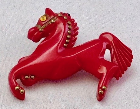BP52 red bakelite carousel horse pin